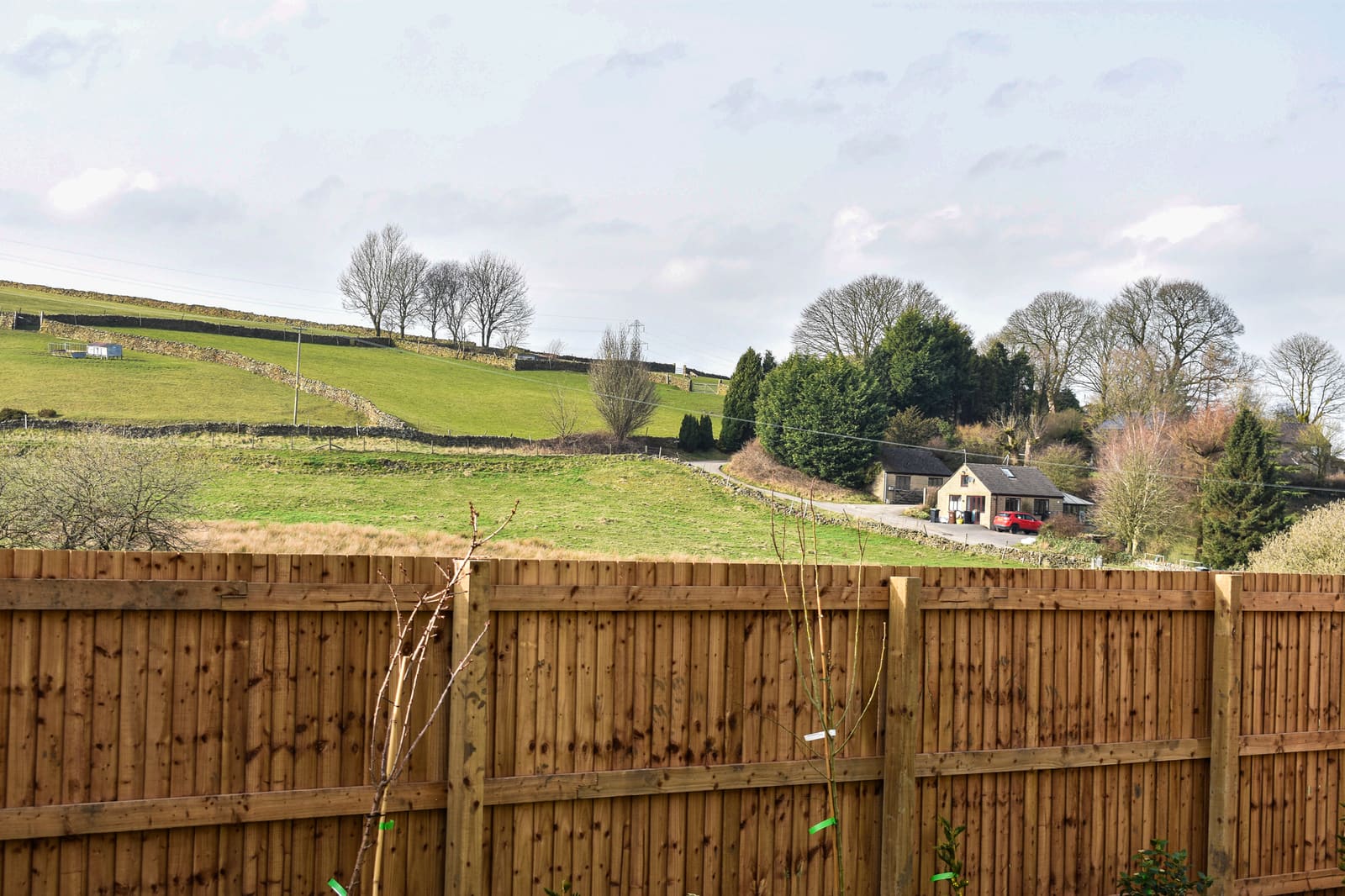 View across the fields towards a Peak District cottage