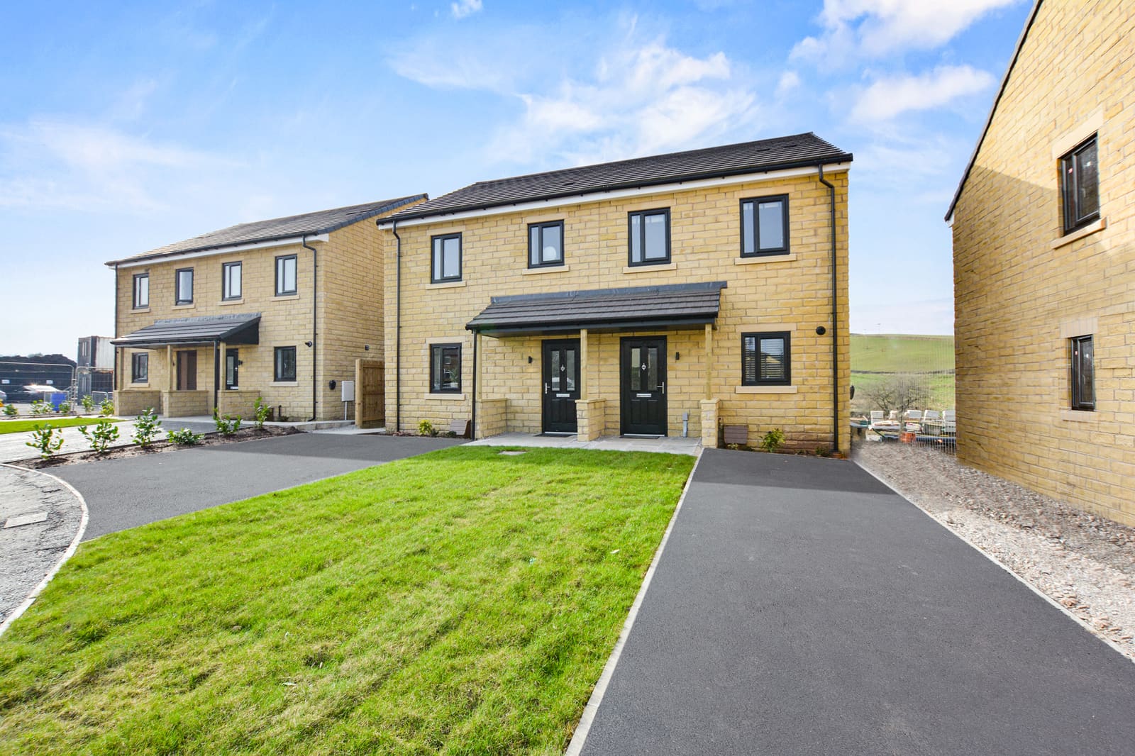Street view of Hallstead Meadow homes with driveways and lawns