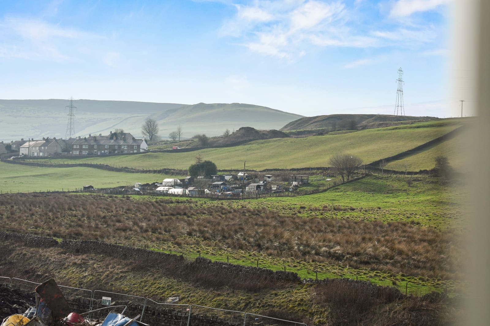 Rolling High Peak countryside near Dove Holes, with a village in the valley below