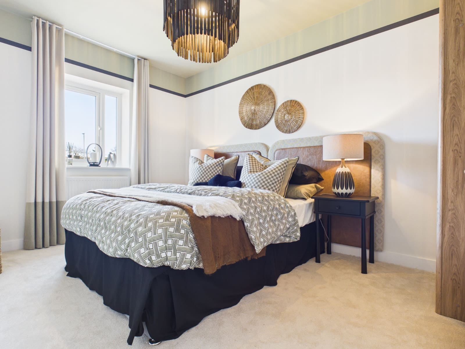 Show home double bedroom with dark headboard