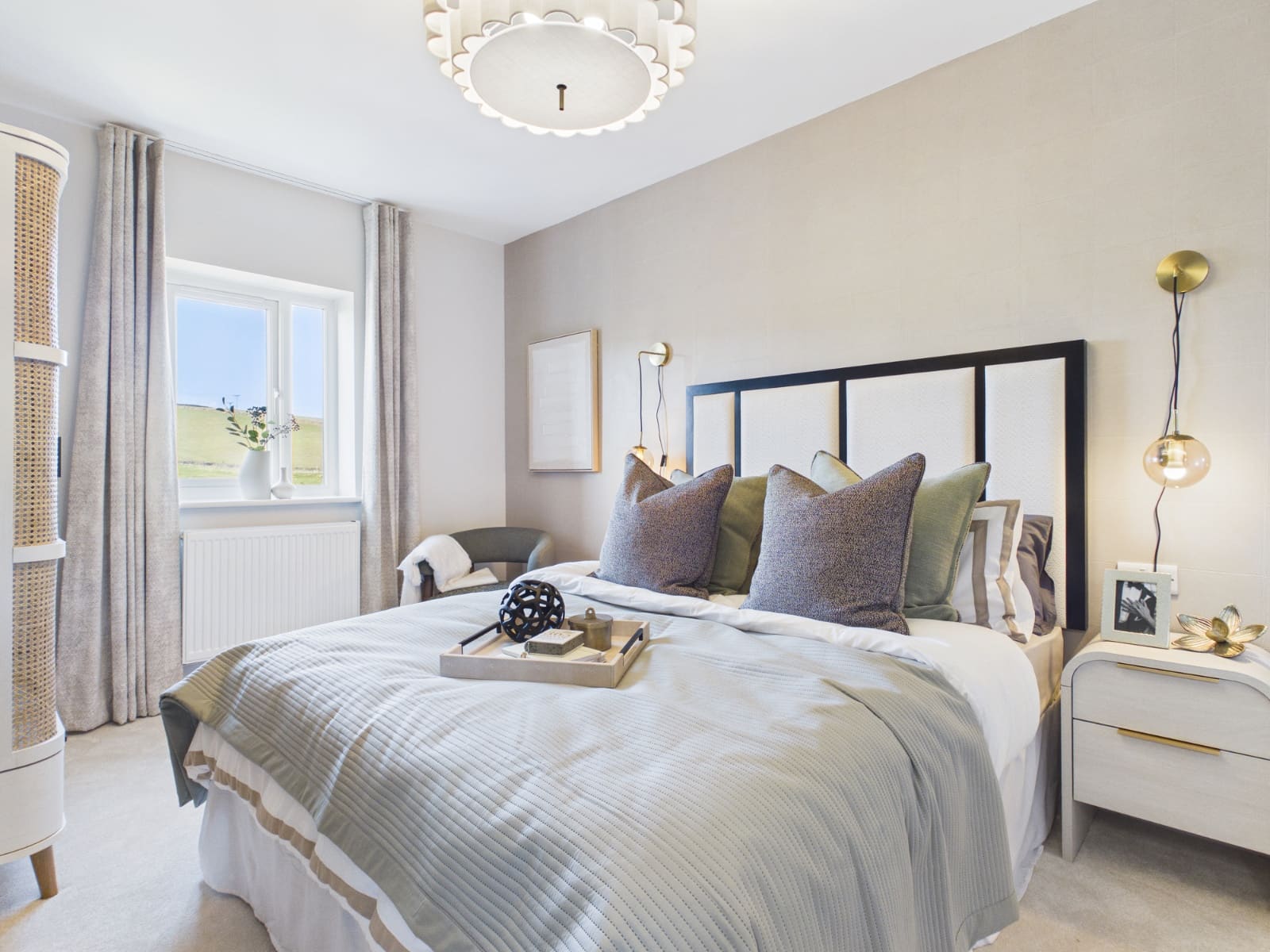 Show home bedroom with grey and navy furnishings
