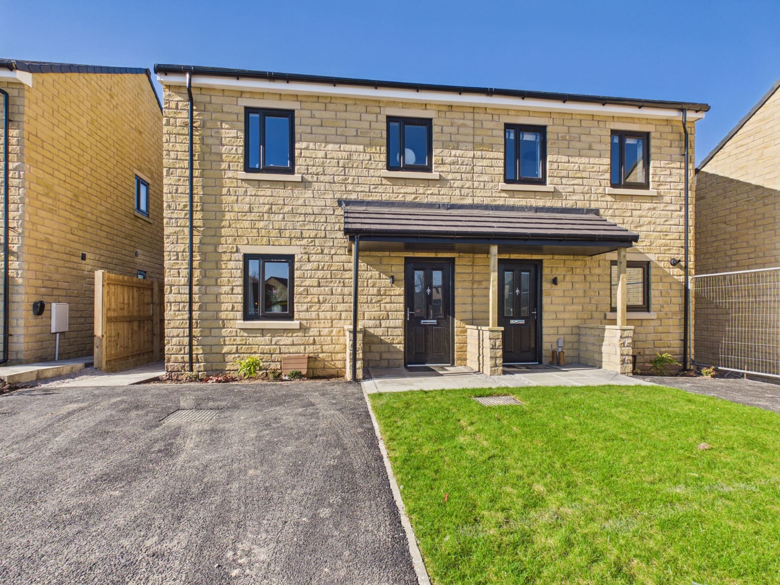 Show home front elevation under a clear blue sky